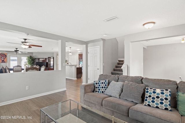 living room with ceiling fan and hardwood / wood-style floors