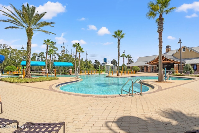 view of pool featuring a gazebo, a patio, and pool water feature