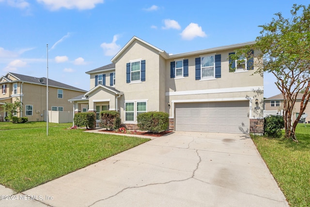 view of front of property with a front lawn and a garage