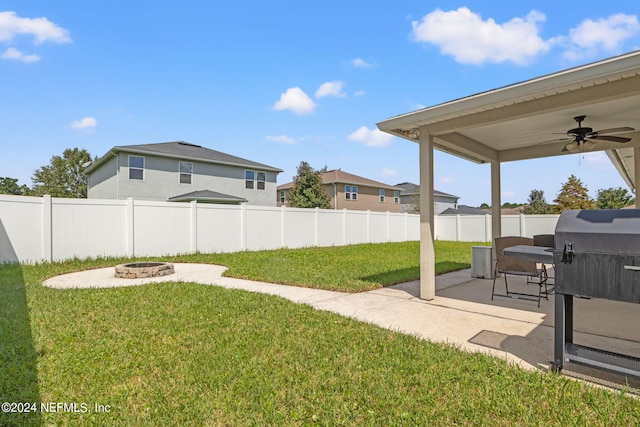 view of yard with a patio, ceiling fan, and a fire pit