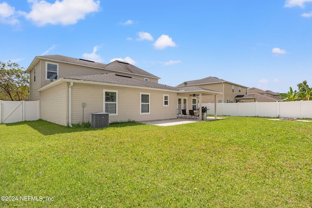 back of property with a lawn, a patio, and central AC unit