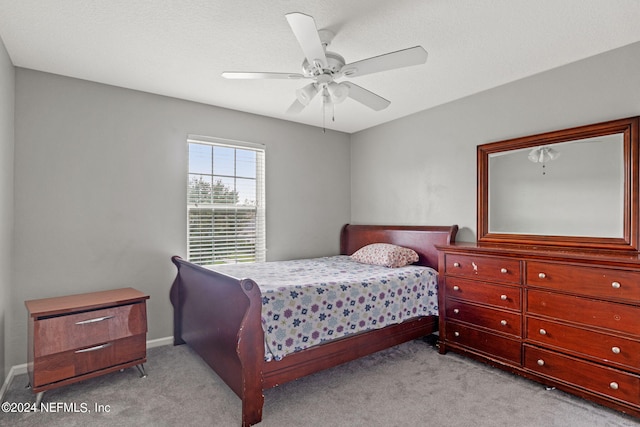 bedroom featuring ceiling fan and light carpet