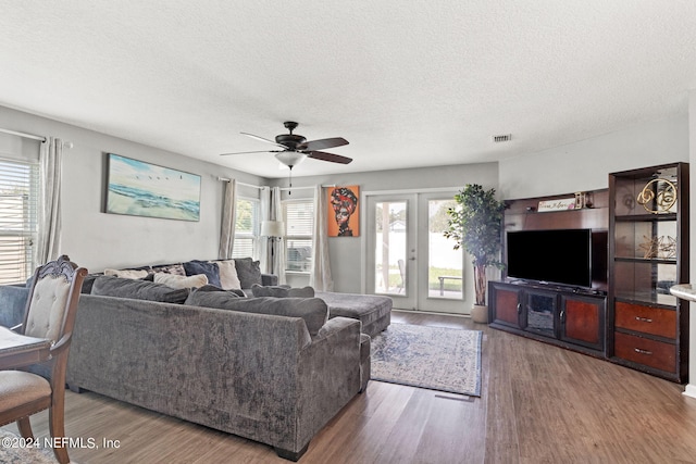 living room with ceiling fan, french doors, plenty of natural light, and hardwood / wood-style floors