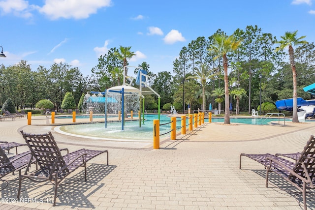 view of play area with pool water feature and a community pool