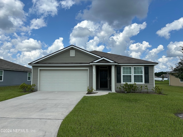 ranch-style house with a garage and a front lawn