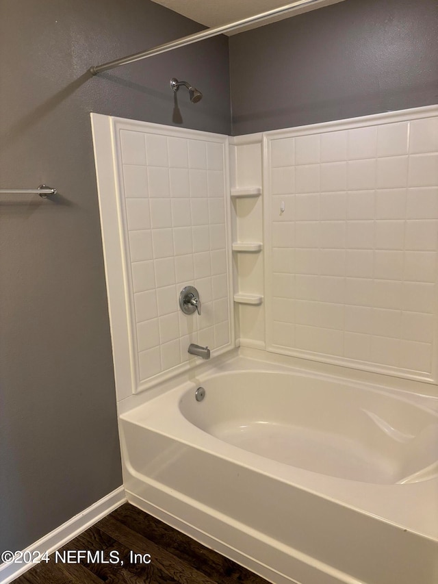 bathroom featuring bathing tub / shower combination and hardwood / wood-style floors