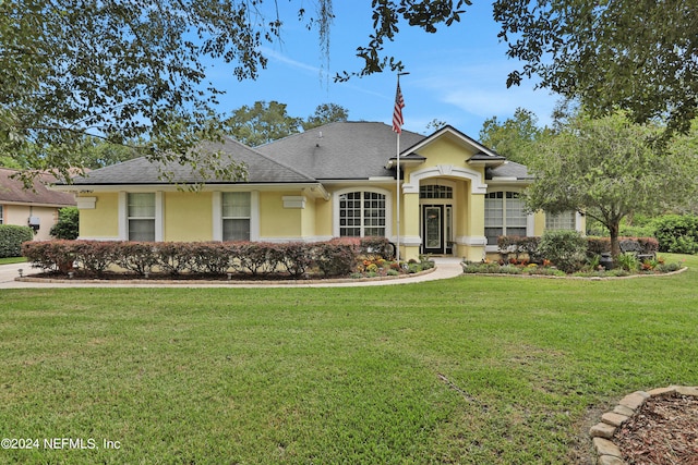 single story home featuring a front lawn