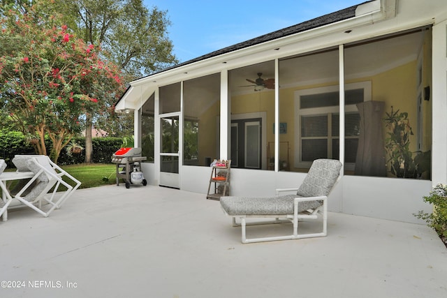 view of patio / terrace with ceiling fan and a sunroom