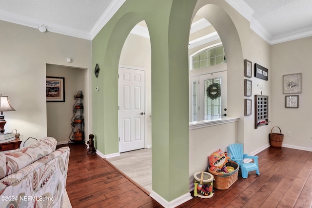 entrance foyer featuring ornamental molding, a textured ceiling, and wood-type flooring