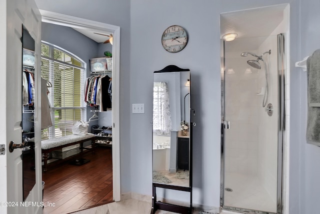 bathroom with hardwood / wood-style floors and walk in shower