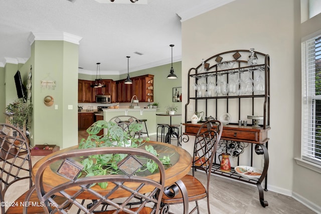 dining room featuring ornamental molding and a textured ceiling