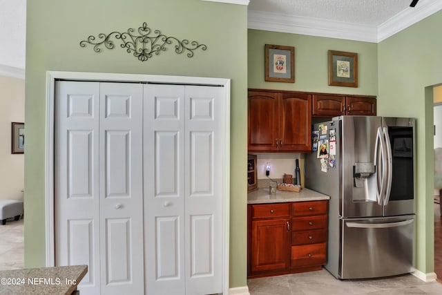 kitchen with stainless steel fridge with ice dispenser, a textured ceiling, ornamental molding, and light tile patterned floors