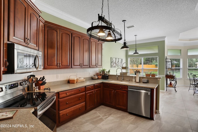 kitchen with hanging light fixtures, kitchen peninsula, sink, and appliances with stainless steel finishes