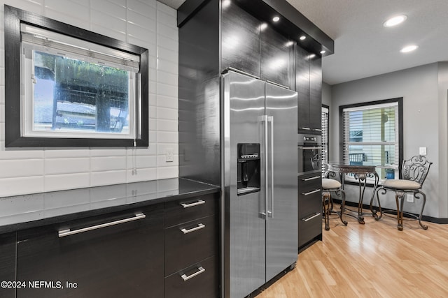 kitchen featuring appliances with stainless steel finishes and light hardwood / wood-style flooring