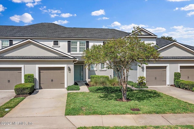 view of front facade with a front yard and a garage