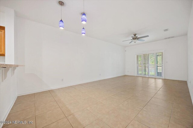 tiled empty room with ceiling fan