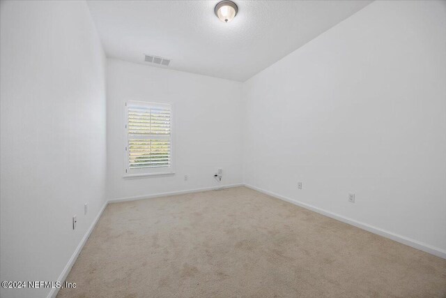 unfurnished room with light colored carpet