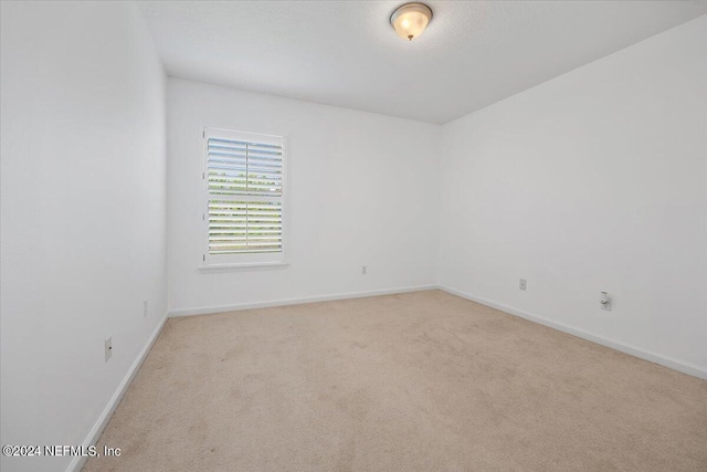 empty room featuring light carpet