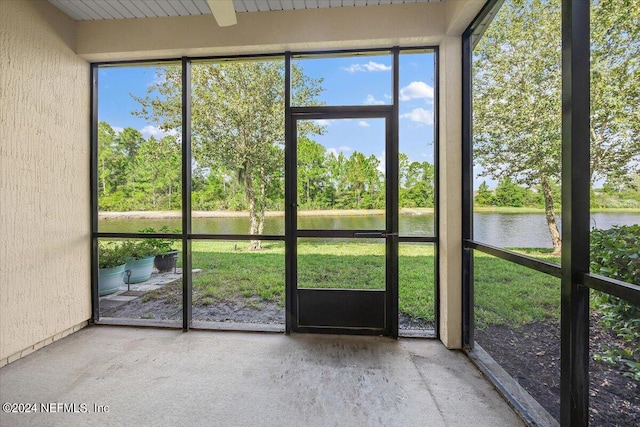 unfurnished sunroom with a water view