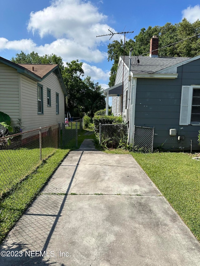 view of side of property with a lawn