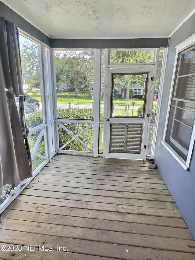 unfurnished sunroom with plenty of natural light