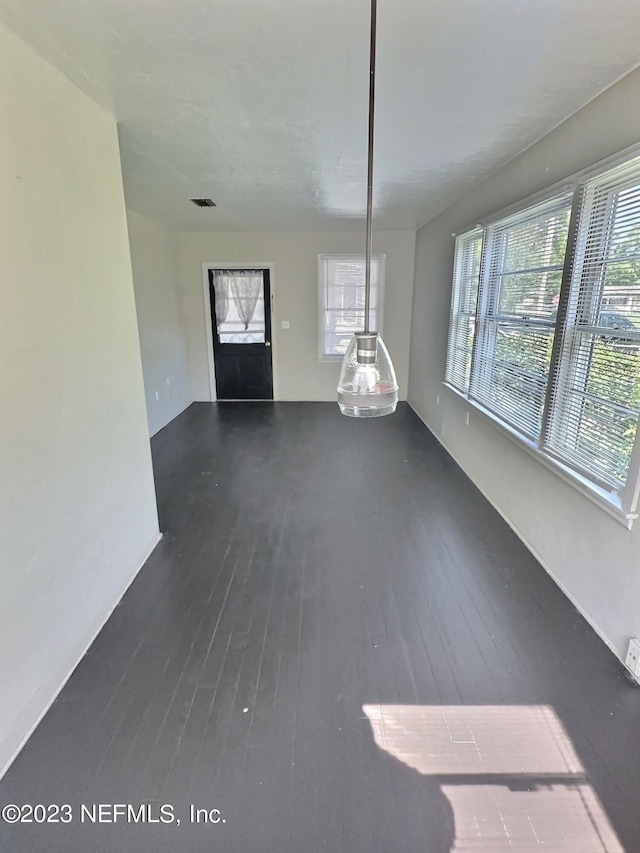 unfurnished living room with dark wood-type flooring