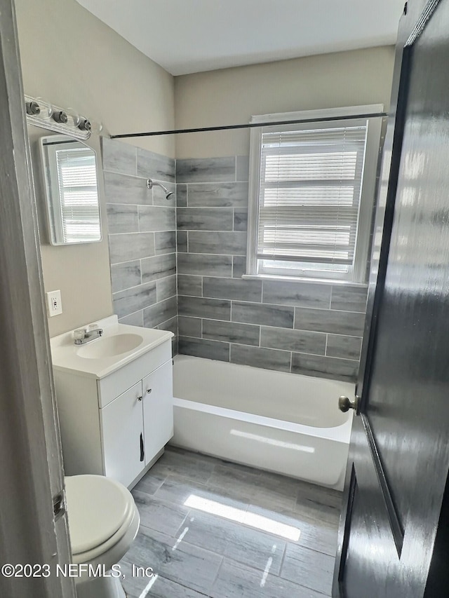 full bathroom with vanity, toilet, and tiled shower / bath