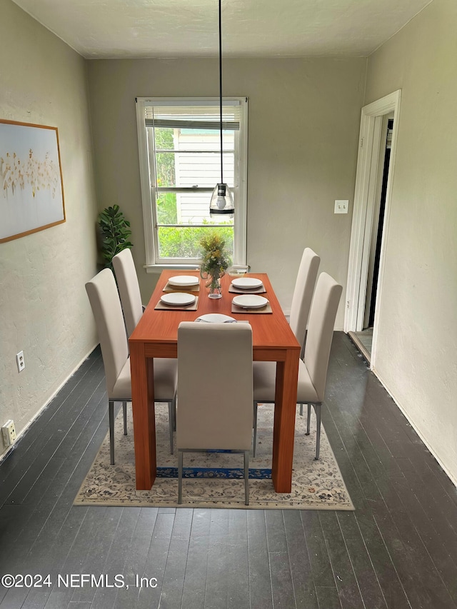 dining space featuring dark wood-type flooring