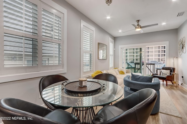 dining space featuring ceiling fan, a healthy amount of sunlight, and light wood-type flooring