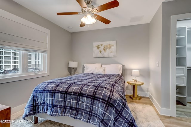 bedroom with light hardwood / wood-style floors and ceiling fan