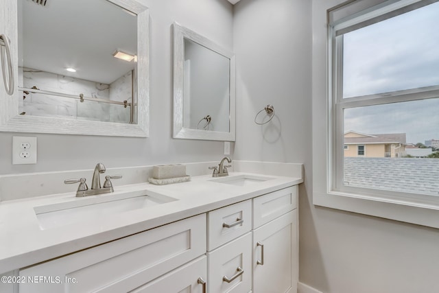 bathroom featuring vanity and a shower with door