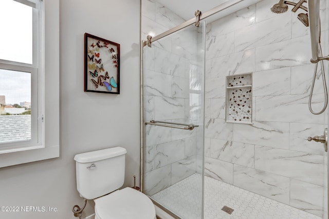 bathroom featuring toilet and walk in shower