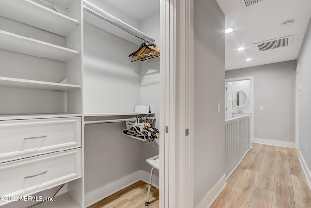 spacious closet featuring light hardwood / wood-style flooring