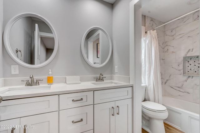 full bathroom featuring vanity, shower / bath combination with curtain, hardwood / wood-style flooring, and toilet