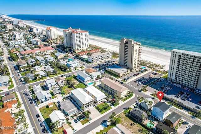 birds eye view of property featuring a view of the beach and a water view