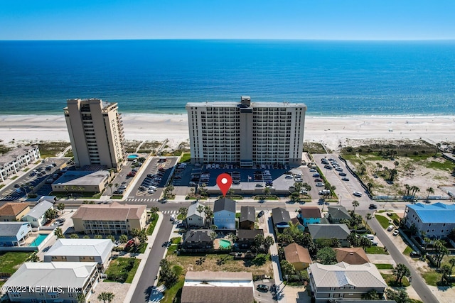 birds eye view of property with a view of the beach and a water view