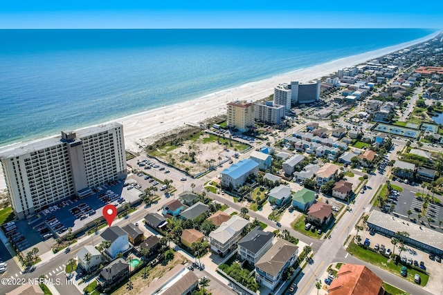 birds eye view of property featuring a water view and a view of the beach