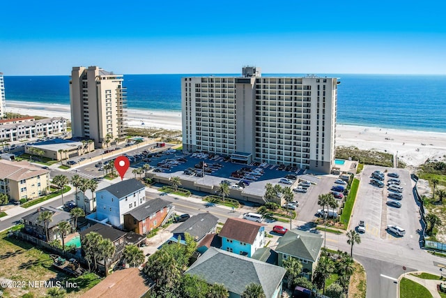 bird's eye view with a water view and a view of the beach