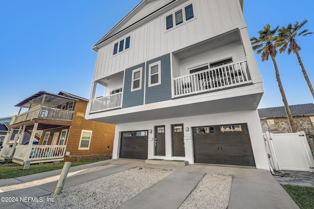 view of front facade with a garage and a balcony