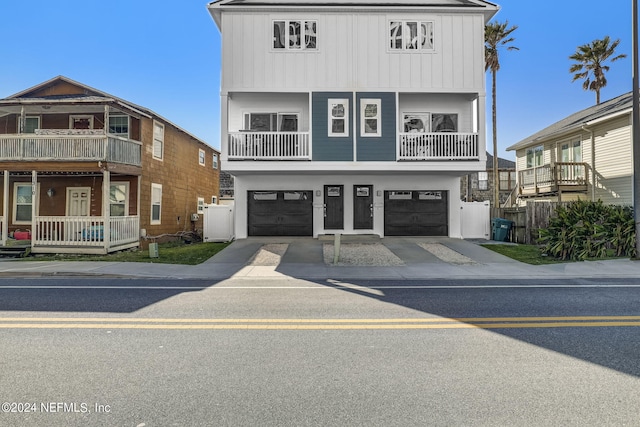 view of front of property featuring a balcony and a garage