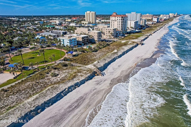 drone / aerial view featuring a water view and a view of the beach