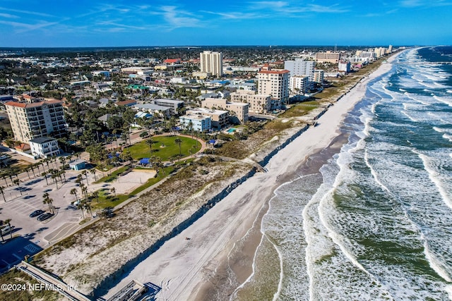 aerial view with a water view and a view of the beach