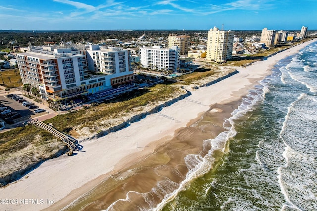 bird's eye view with a water view and a beach view