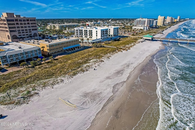 bird's eye view with a water view and a beach view