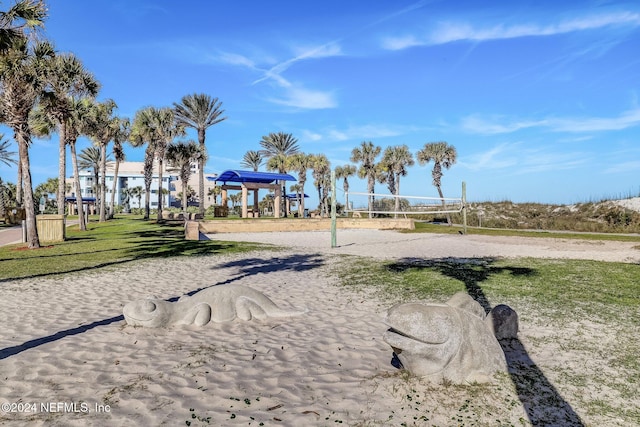 view of community with a yard and volleyball court