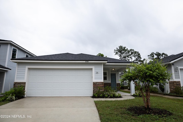 view of front of home featuring a front yard and a garage