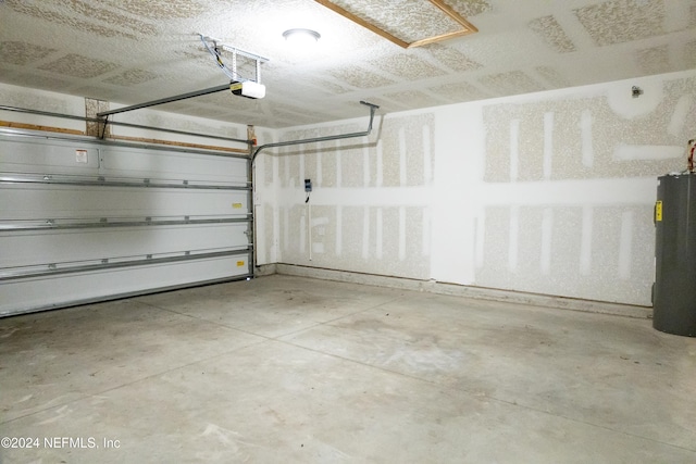 garage with a garage door opener and electric water heater