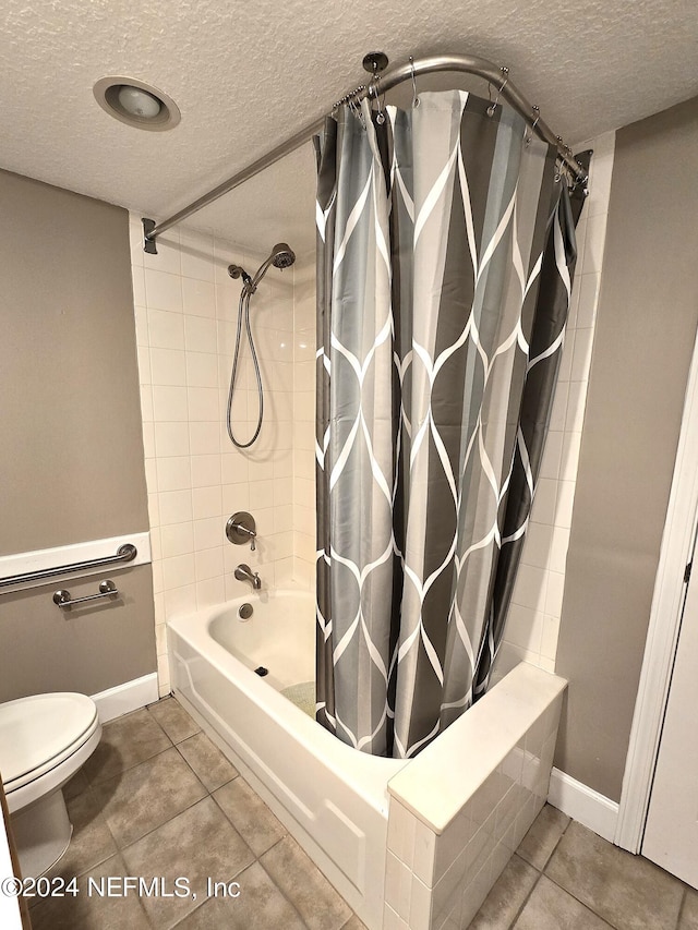 bathroom featuring a textured ceiling, toilet, tile patterned floors, and shower / bathtub combination with curtain