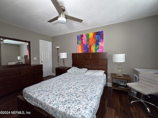 bedroom with a textured ceiling, dark wood-type flooring, and ceiling fan