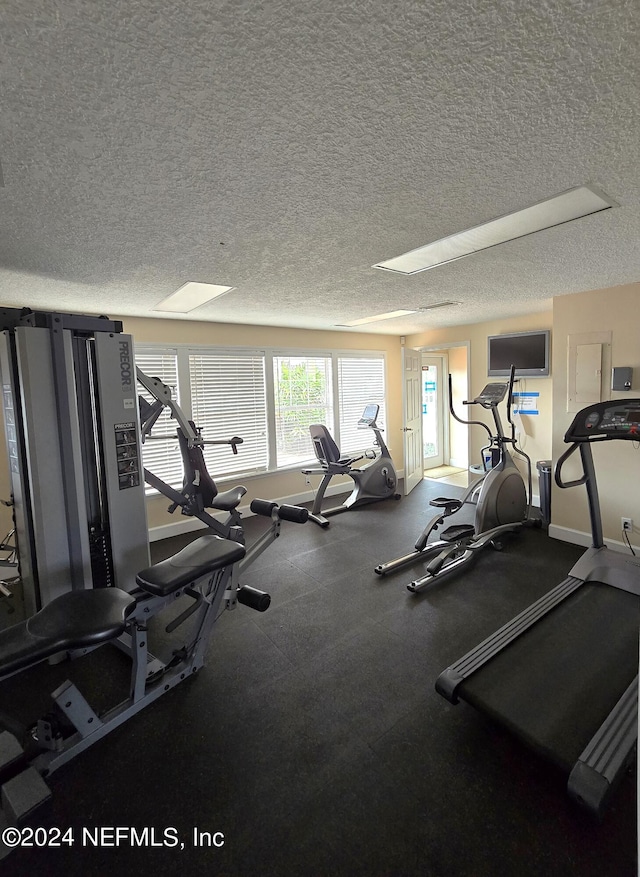 exercise room with a textured ceiling